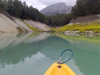 Vista panorámica del embalse de Guadalest desde un kayak, con el cielo reflejado en el agua